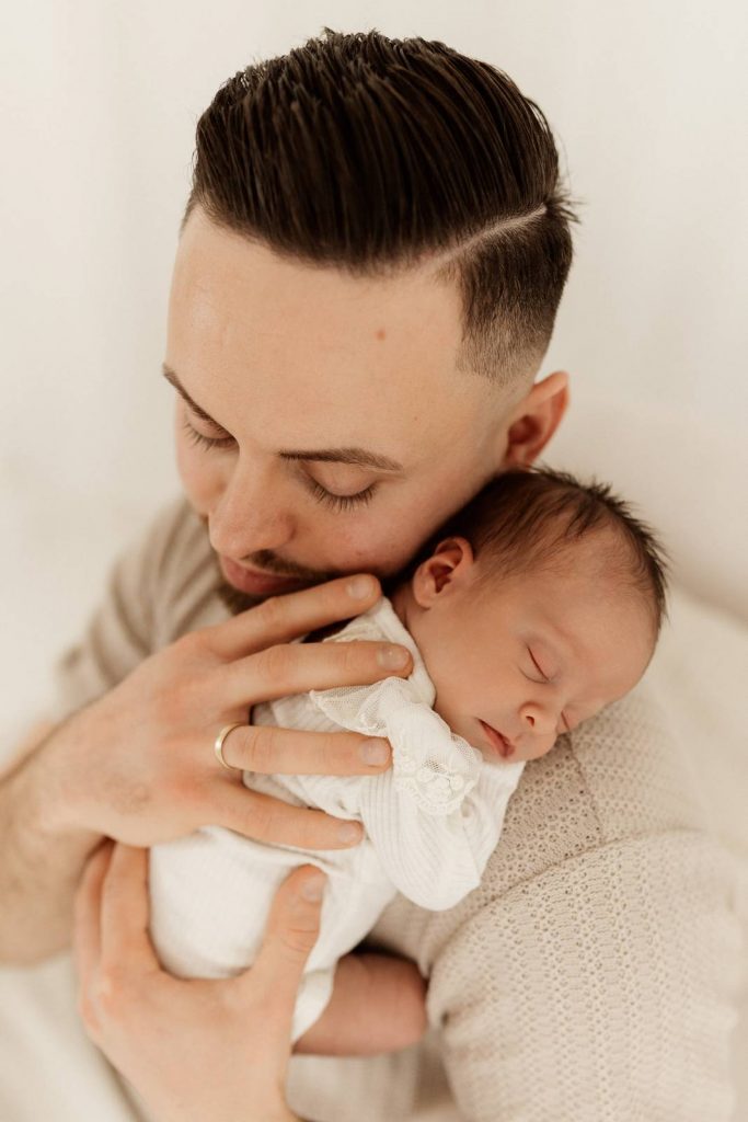 Baby gehalten von Papa beim Babyshooting