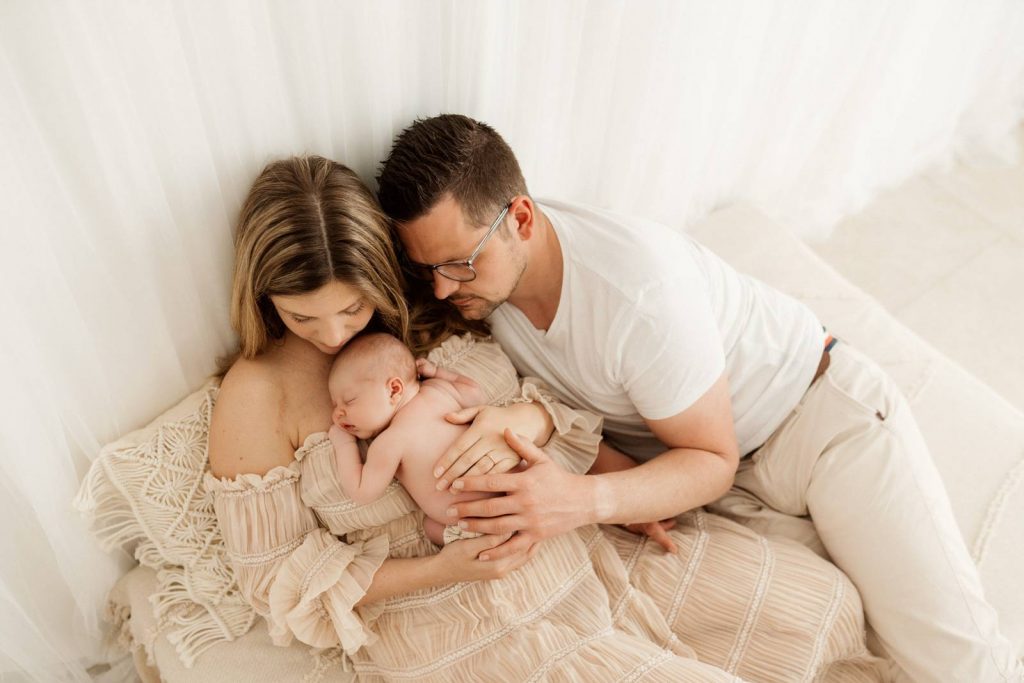 Baby gehalten von Mama und Papa beim Babyshooting