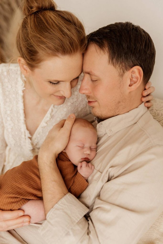 Baby gehalten von Mama und Papa beim Babyshooting